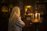 people-lighting-candles-in-church-in-celebration-of-greek-easter